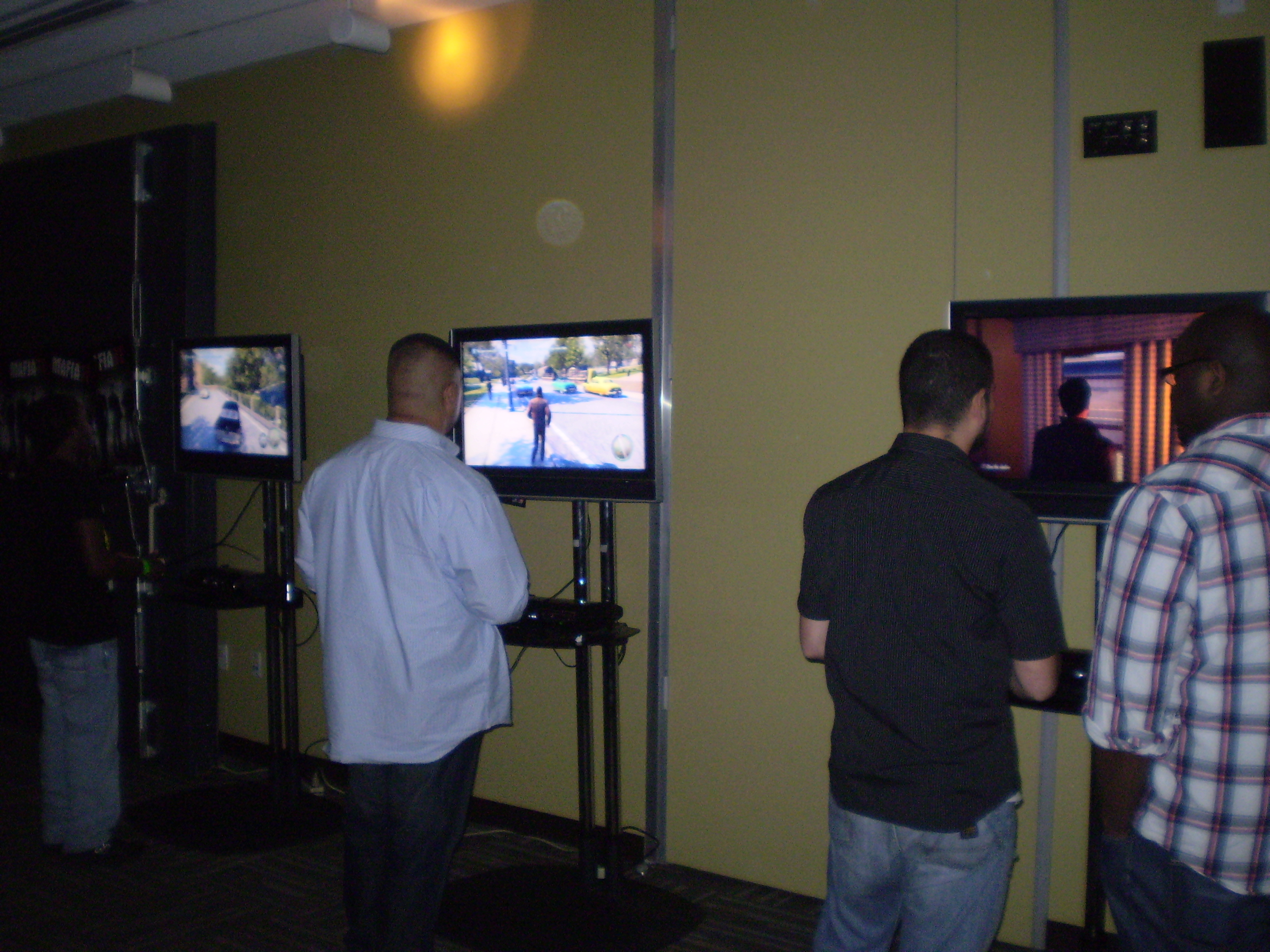 Attendees play Mafia II on the PS3.